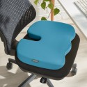 Poduszka Leitz Ergo Cosy w niebieskim kolorze, jest położona na czarne krzesło biurowe.